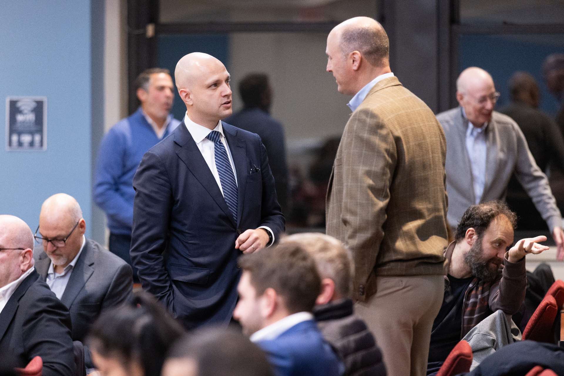Max Rayetsky in conversation with an attendee during the networking reception