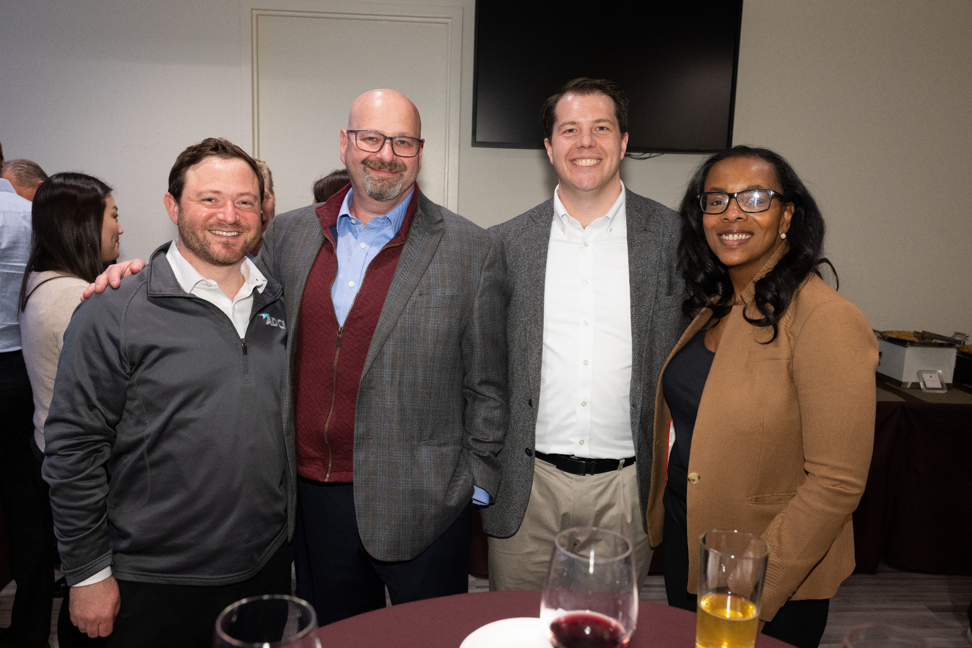 Attendees posing together during the reception following the airport development panel