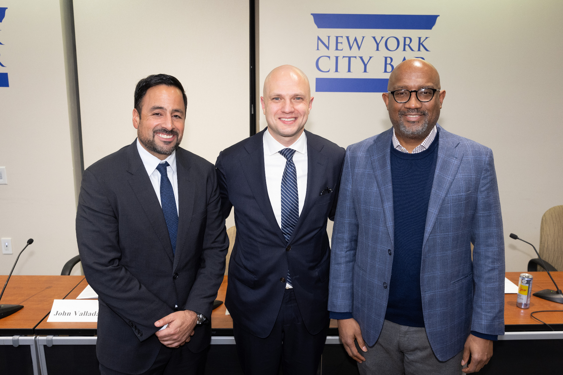 Max Rayetsky with John Valladares and a fellow panelist at the dais after the discussion